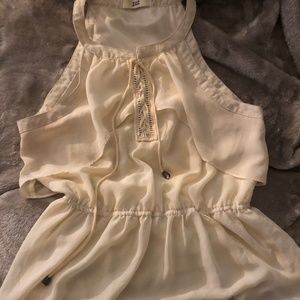 Cream sleeveless shirt